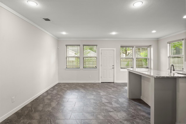 2024 Kraft St, Dallas, TX 75212 - kitchen featuring crown molding, baseboards, light stone counters, and recessed lighting