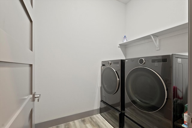 1595 Bledsoe Rd, Gunter, TX 75058 - laundry room featuring washing machine and clothes dryer, wood finished floors, and baseboards