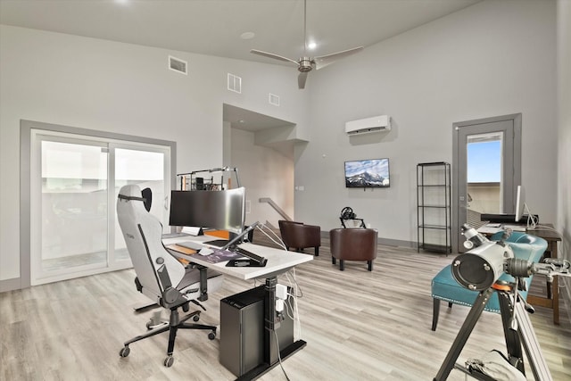 1595 Bledsoe Rd, Gunter, TX 75058 - office area featuring a towering ceiling, a wall mounted air conditioner, light wood finished floors, baseboards, and a ceiling fan