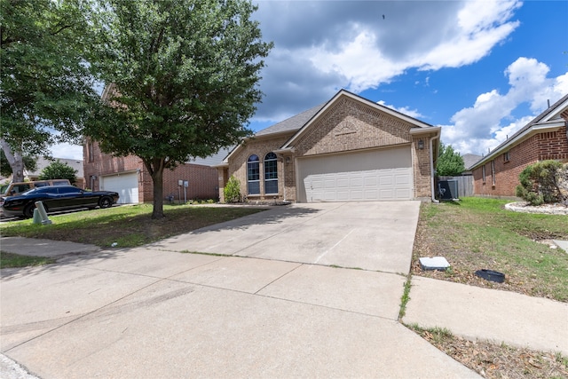 4356 Mountain Crest Dr, Fort Worth, TX 76123 - view of front facade with brick siding, concrete driveway, an attached garage, and a front lawn