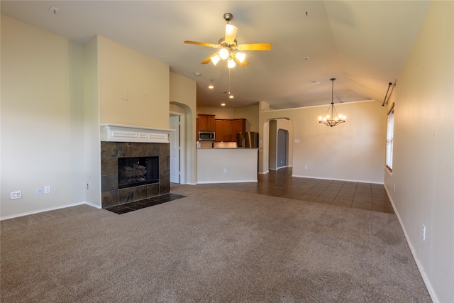 4356 Mountain Crest Dr, Fort Worth, TX 76123 - unfurnished living room with dark carpet, a fireplace, a ceiling fan, a chandelier, and arched walkways