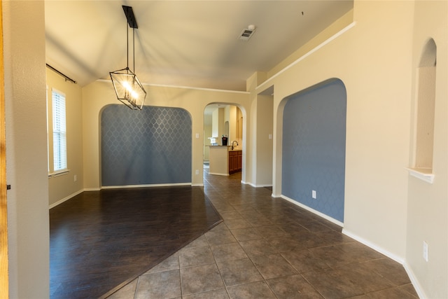 4356 Mountain Crest Dr, Fort Worth, TX 76123 - unfurnished room with arched walkways, dark tile patterned flooring, and baseboards