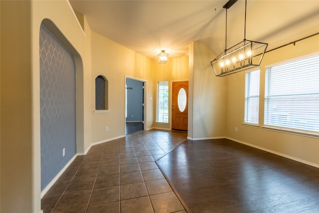 4356 Mountain Crest Dr, Fort Worth, TX 76123 - foyer with a chandelier, baseboards, and dark tile patterned flooring