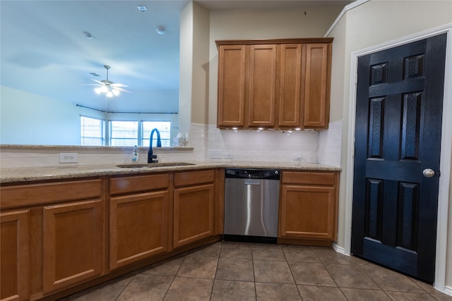 4356 Mountain Crest Dr, Fort Worth, TX 76123 - kitchen with stainless steel dishwasher, a sink, brown cabinetry, tile patterned floors, and ceiling fan