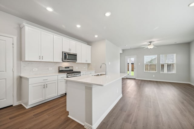 518 Willet Dr, Mckinney, TX 75069 - kitchen with appliances with stainless steel finishes, a sink, dark wood-style floors, backsplash, and a kitchen island with sink