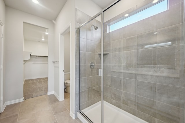 518 Willet Dr, Mckinney, TX 75069 - bathroom with a stall shower, toilet, tile patterned flooring, a spacious closet, and baseboards