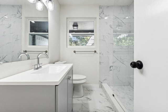 full bathroom featuring marble look tiles, toilet, vanity, a marble finish shower, and baseboards