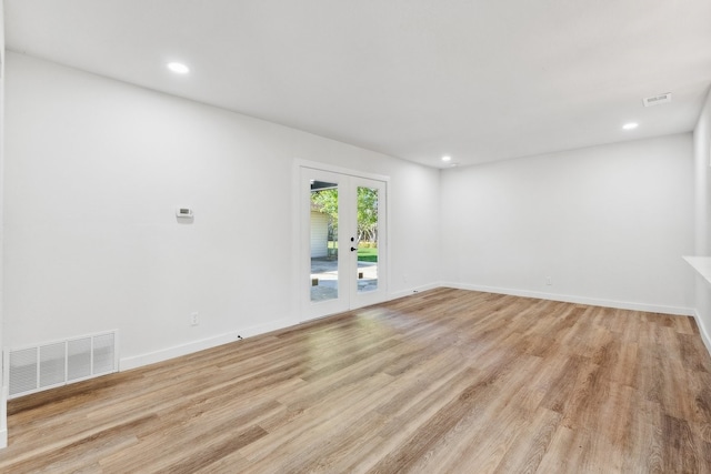 spare room with french doors, light wood-type flooring, recessed lighting, and baseboards