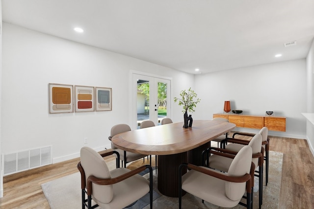 dining space with french doors, light wood finished floors, recessed lighting, and baseboards