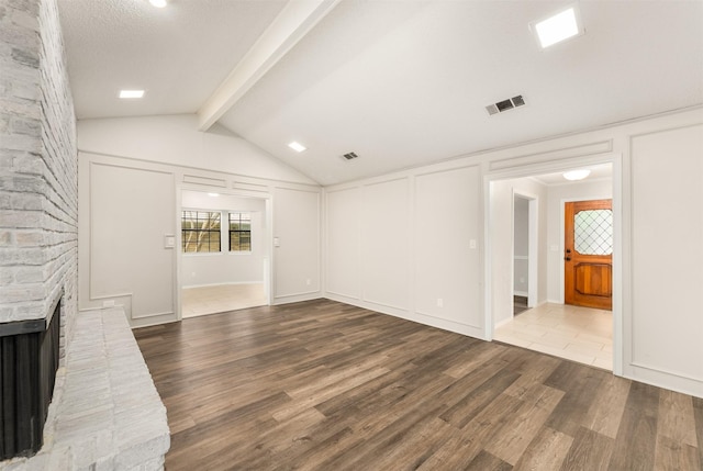 unfurnished living room with wood finished floors and a fireplace