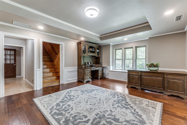 office featuring crown molding, dark wood-style flooring, a raised ceiling, and recessed lighting