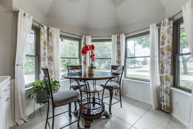 sunroom / solarium featuring vaulted ceiling and plenty of natural light