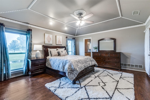bedroom featuring wood finished floors, ornamental molding, vaulted ceiling, a ceiling fan, and ensuite bathroom
