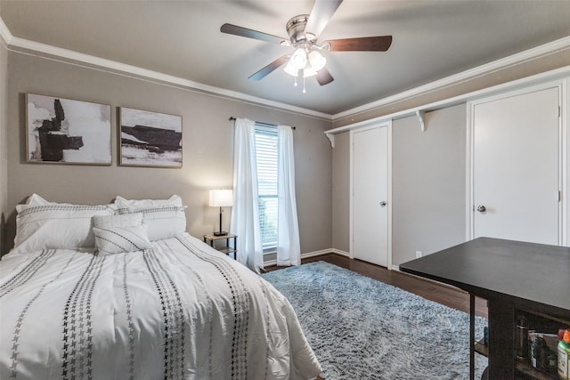 bedroom with wood finished floors, ornamental molding, a ceiling fan, and baseboards