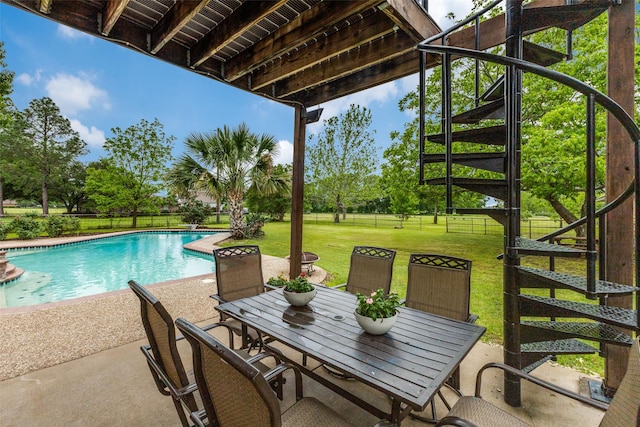 view of pool with a patio area and outdoor dining area
