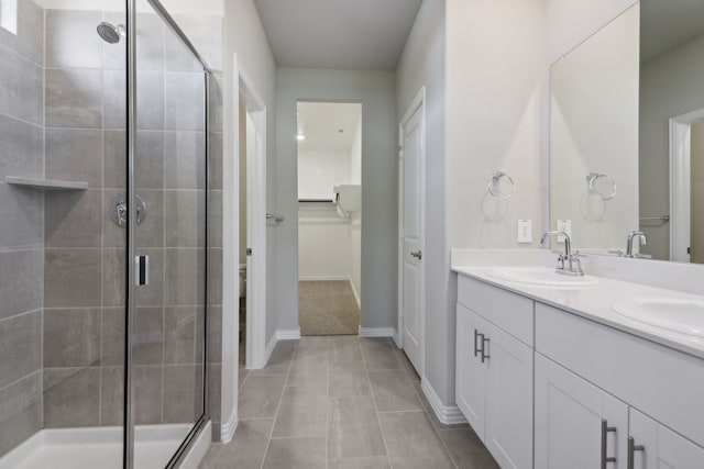 512 Willet Dr, Mckinney, TX 75069 - bathroom with a stall shower, double vanity, tile patterned floors, and baseboards