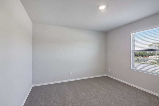 512 Willet Dr, Mckinney, TX 75069 - empty room featuring dark colored carpet and baseboards