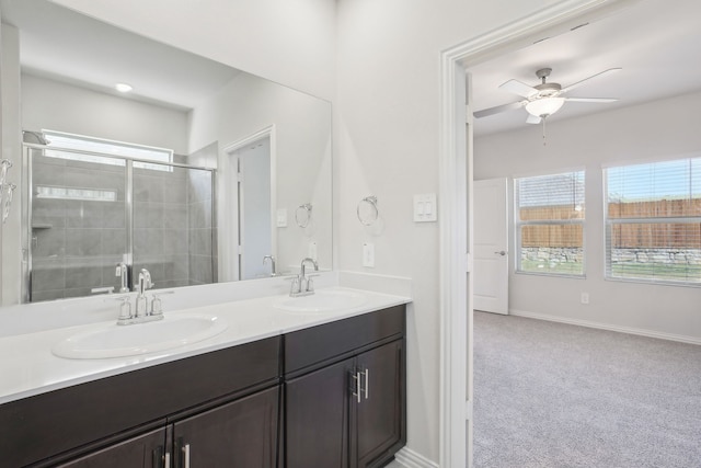 bathroom with plenty of natural light, a stall shower, double vanity, and a ceiling fan