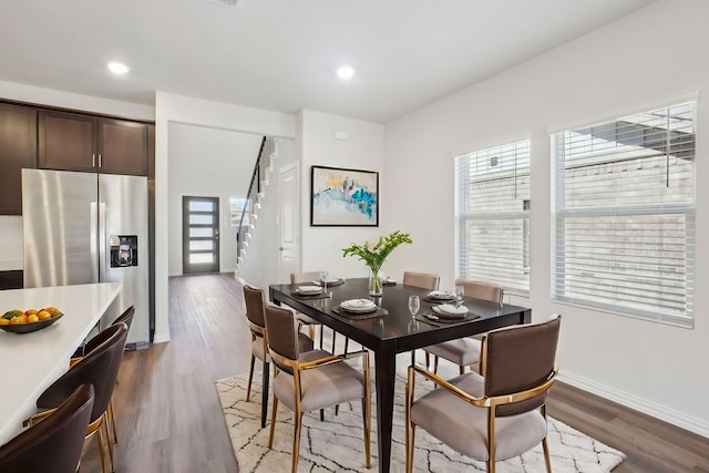 dining room with plenty of natural light, stairway, wood finished floors, baseboards, and recessed lighting