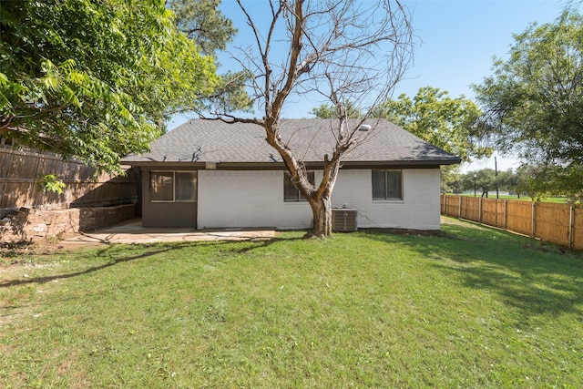 1112 Terrace Trl, Carrollton, TX 75006 - back of house featuring central AC, roof with shingles, brick siding, and a patio
