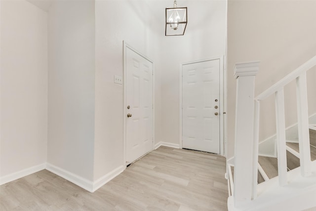 1112 Terrace Trl, Carrollton, TX 75006 - foyer featuring light wood-style flooring, stairs, a chandelier, and baseboards