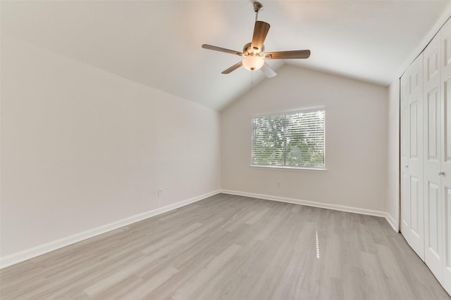 1112 Terrace Trl, Carrollton, TX 75006 - unfurnished bedroom with light wood-style flooring, a closet, lofted ceiling, baseboards, and a ceiling fan