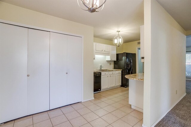 3209 Woodlark Dr, Fort Worth, TX 76123 - kitchen featuring black appliances, a chandelier, a sink, and white cabinets