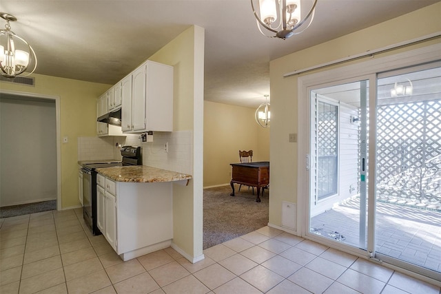 3209 Woodlark Dr, Fort Worth, TX 76123 - kitchen with black range with electric cooktop, a chandelier, white cabinetry, and light tile patterned flooring