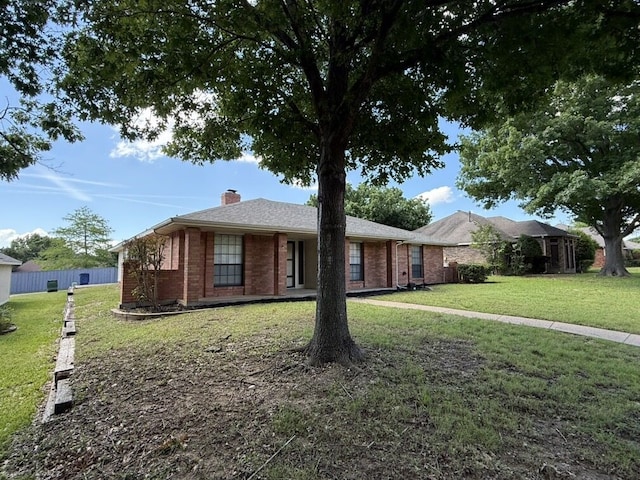 single story home with a chimney and brick siding