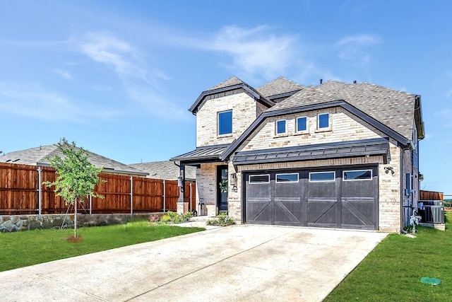 601 Wilderness Point Ln, Anna, TX 75409 - view of front of home featuring central AC, a standing seam roof, concrete driveway, a garage, and metal roof