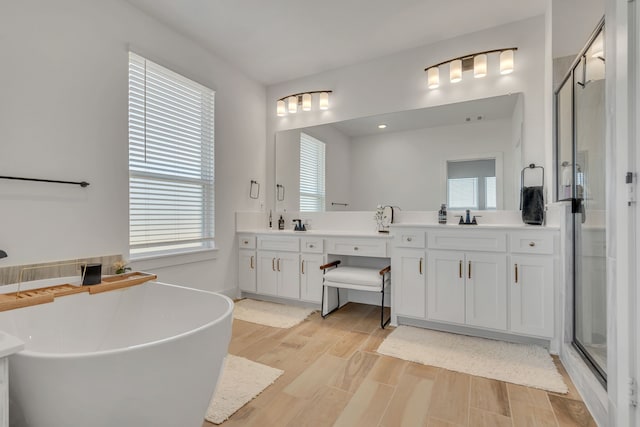 601 Wilderness Point Ln, Anna, TX 75409 - full bath featuring a shower stall, double vanity, wood finished floors, and a soaking tub