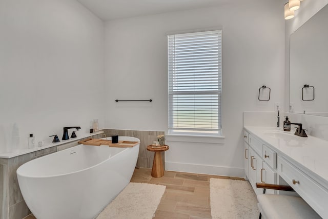 601 Wilderness Point Ln, Anna, TX 75409 - bathroom featuring vanity, a soaking tub, and wood finished floors