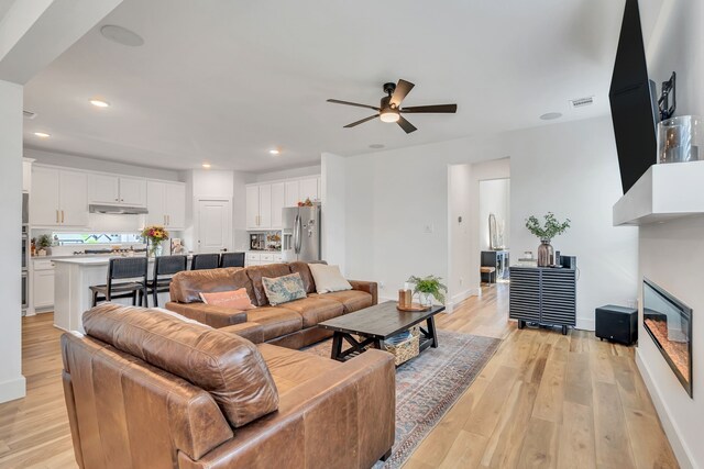 601 Wilderness Point Ln, Anna, TX 75409 - living room with ceiling fan, light wood-style floors, baseboards, and recessed lighting