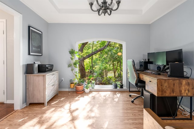 office featuring a chandelier, wood finished floors, a raised ceiling, and baseboards