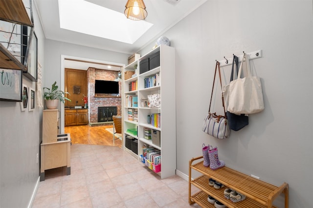hall featuring a skylight and baseboards