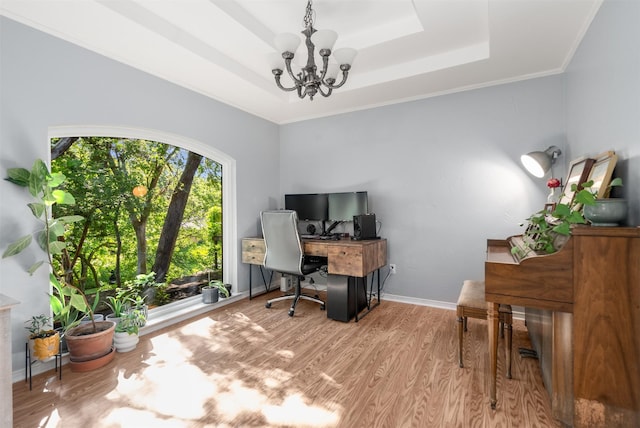 office area with a raised ceiling, a chandelier, wood finished floors, and baseboards