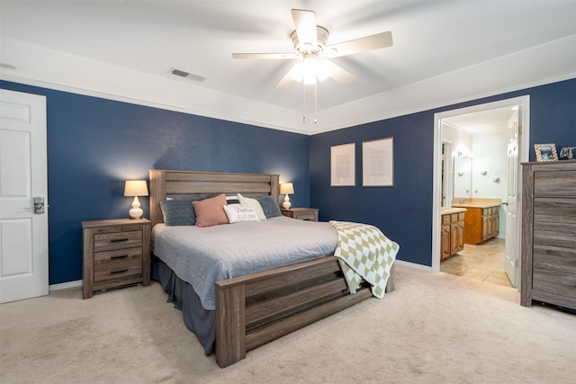 bedroom featuring light colored carpet, baseboards, connected bathroom, and a ceiling fan
