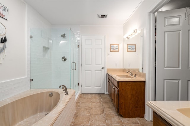 bathroom with vanity, a bath, and a stall shower