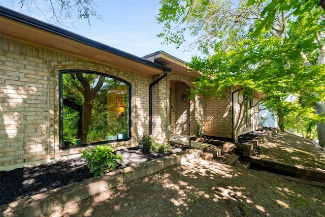 doorway to property with brick siding
