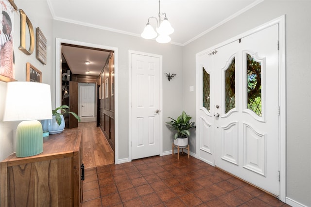 foyer featuring a chandelier, crown molding, and baseboards