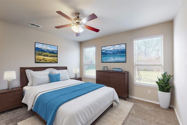 13013 Palancar Dr, Fort Worth, TX 76244 - bedroom with multiple windows, baseboards, light colored carpet, and ceiling fan