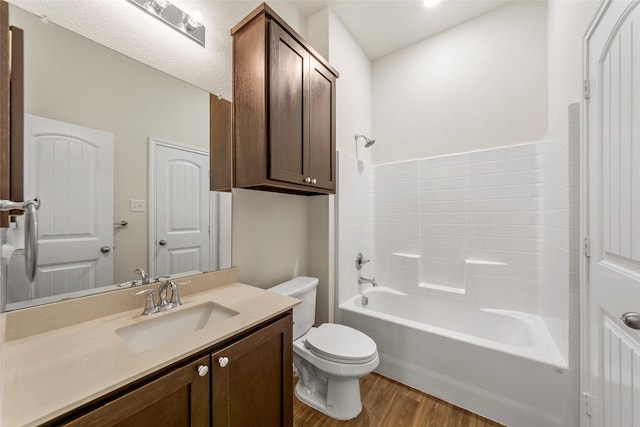 425 Tobin Dr, Seagoville, TX 75159 - bathroom featuring wood finished floors, toilet, vanity, and tub / shower combination
