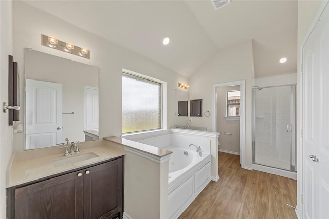 425 Tobin Dr, Seagoville, TX 75159 - bathroom with a stall shower, lofted ceiling, a garden tub, vanity, and wood finished floors
