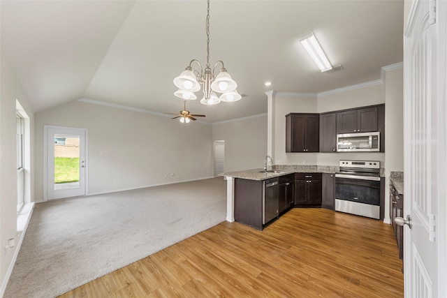 425 Tobin Dr, Seagoville, TX 75159 - kitchen with appliances with stainless steel finishes, dark brown cabinetry, open floor plan, light stone counters, and baseboards