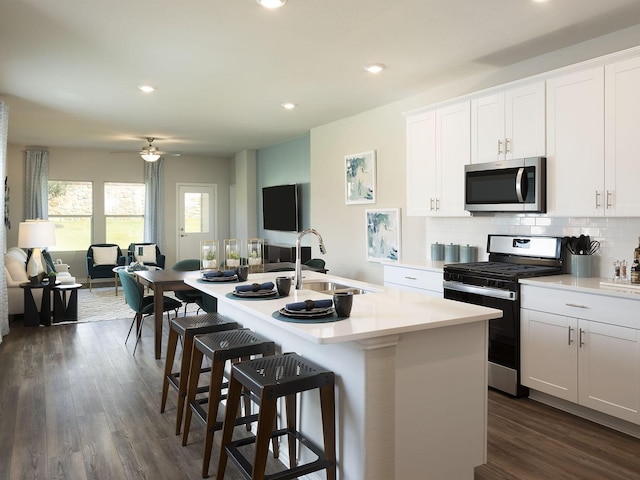 514 Willet Dr, Mckinney, TX 75069 - kitchen with stainless steel appliances, a sink, open floor plan, an island with sink, and a breakfast bar area