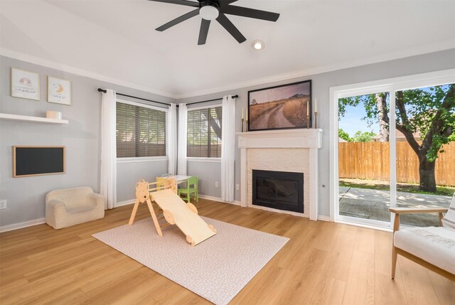 2038 Frontier Trl, Lewisville, TX 75067 - living room featuring a ceiling fan, a glass covered fireplace, plenty of natural light, light wood-type flooring, and lofted ceiling