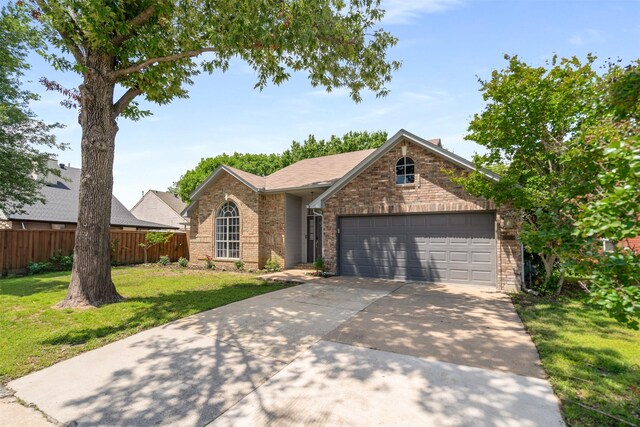 2038 Frontier Trl, Lewisville, TX 75067 - view of front facade featuring concrete driveway, brick siding, and a garage