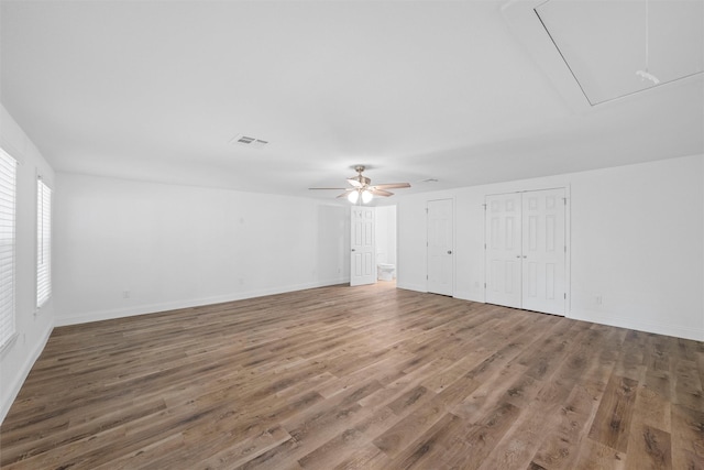 1720 Bagby Ave, Waco, TX 76706 - unfurnished living room featuring attic access, wood finished floors, ceiling fan, and baseboards