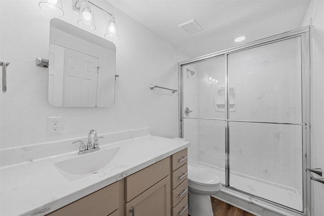 1720 Bagby Ave, Waco, TX 76706 - full bath with a shower stall, toilet, wood finished floors, and vanity