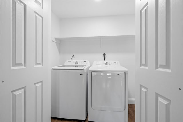 1720 Bagby Ave, Waco, TX 76706 - clothes washing area featuring washing machine and dryer and dark wood-style flooring